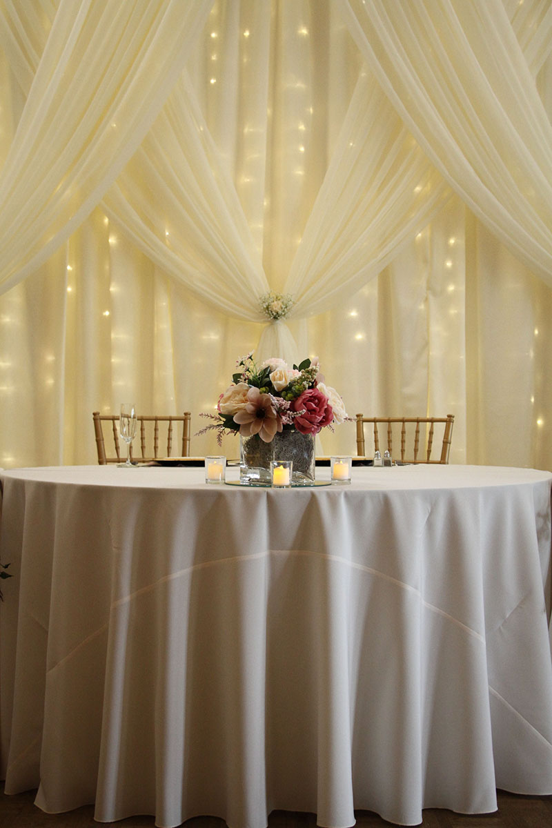 Sheer Ivory Backdrop With Sheer Ivory Front Layer Crisscross Tied With Mini Lights